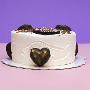Sweetheart Celebration: Vanilla Cream Birthday Cake with Chocolate Hearts and Colorful Smarties