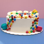 Vanilla Dreamland: Creamy Vanilla Birthday Cake with Whipped Cream Blossoms and Colorful Smarties